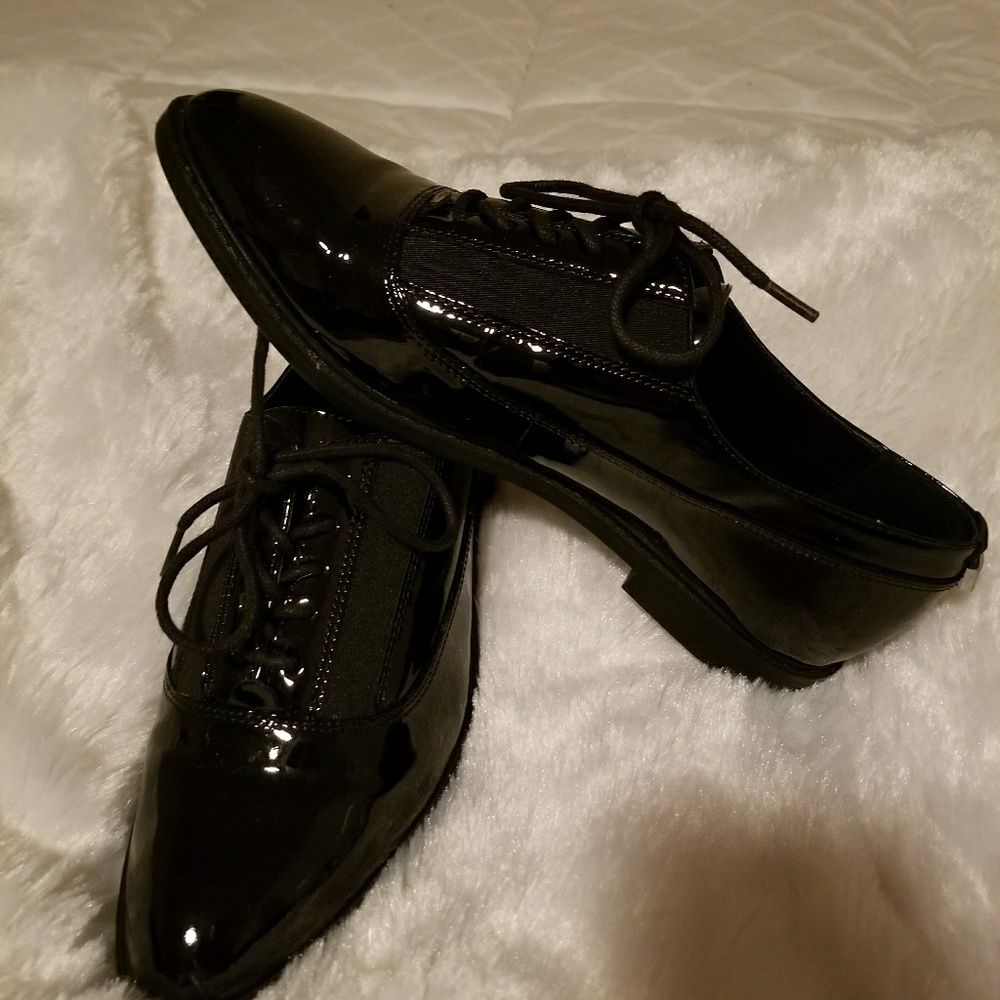 Womens Calvin Klein patent leather tuxedo shoes.